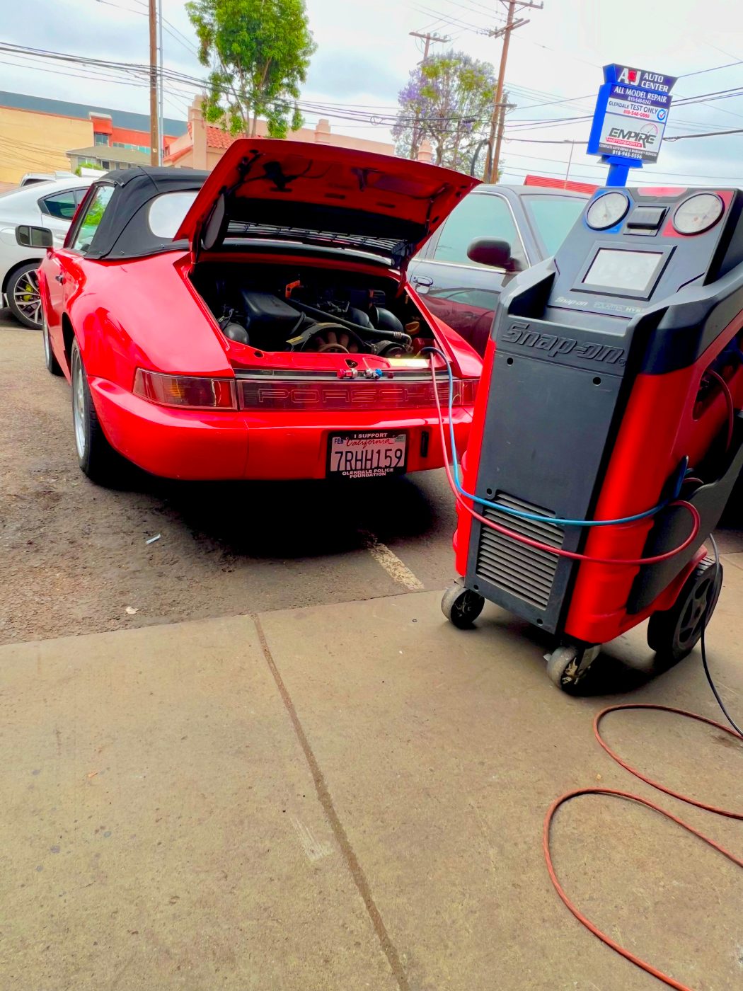 Red Porsche 911 in for an air conditioning service at All Model Repair